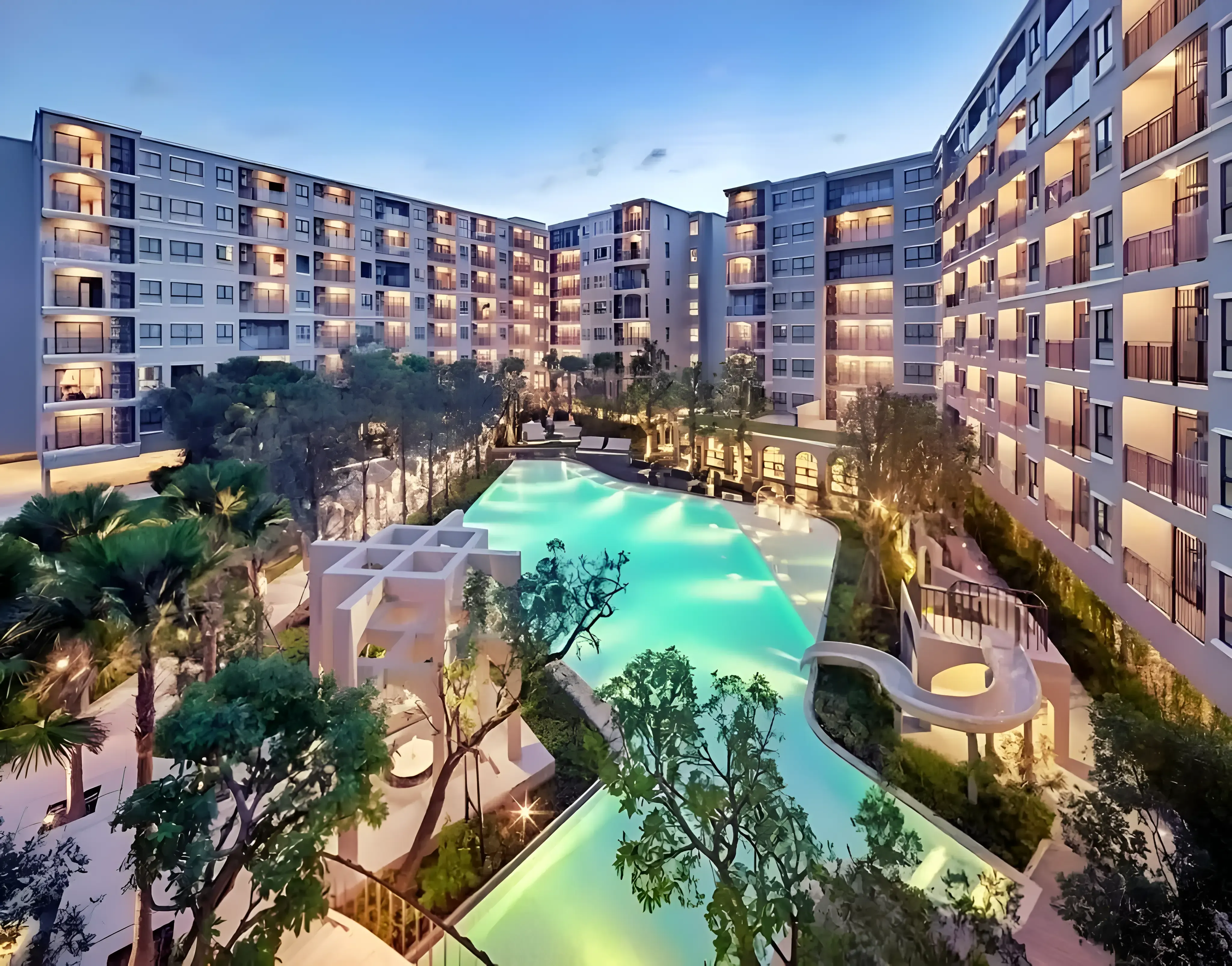 La Casita Hua Hin expansive lagoon pool and residential building at dusk