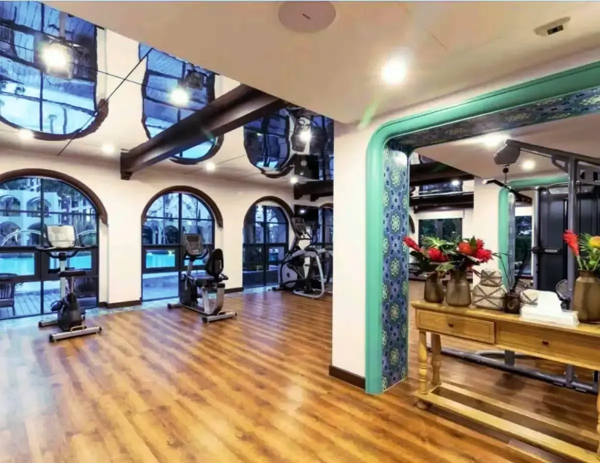 Modern on-site fitness center with cardio and weight equipment