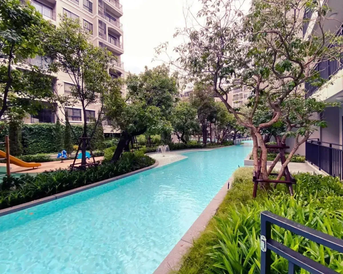 Resort pool area featuring children water slide and sun loungers